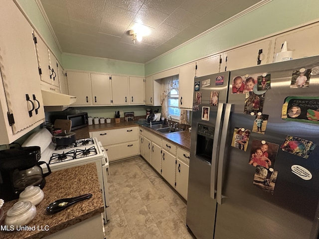 kitchen with stainless steel refrigerator with ice dispenser, ornamental molding, gas range gas stove, sink, and white cabinetry