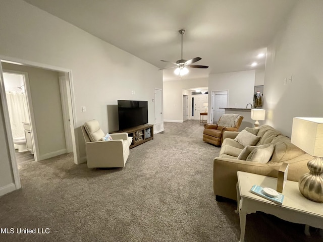 carpeted living room featuring ceiling fan and lofted ceiling