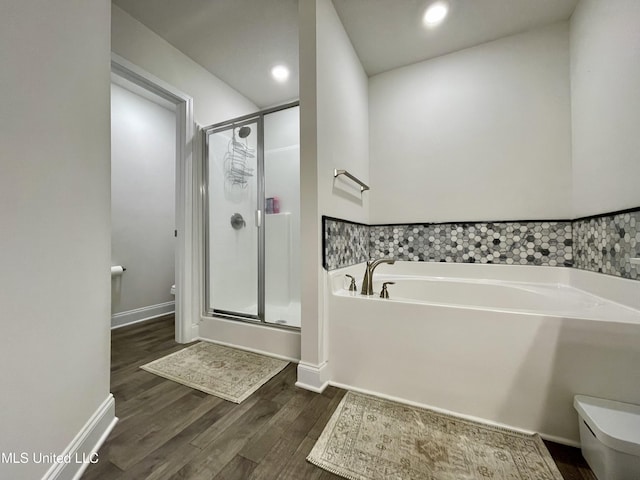 bathroom with separate shower and tub, hardwood / wood-style flooring, and toilet