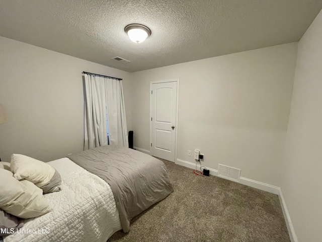 carpeted bedroom featuring a textured ceiling