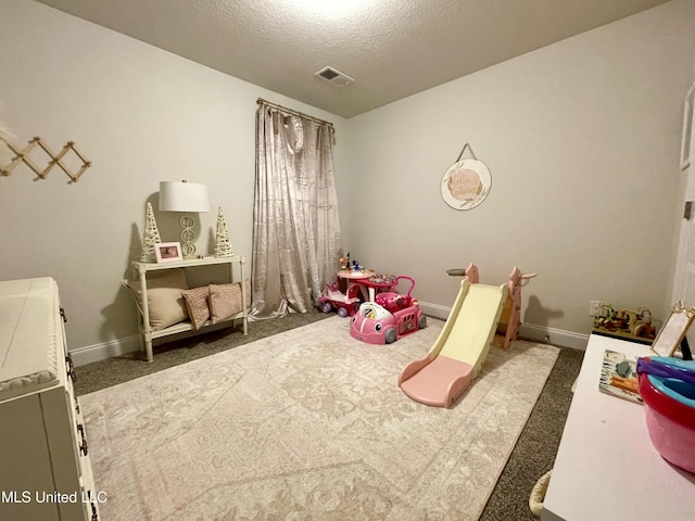 game room with carpet and a textured ceiling