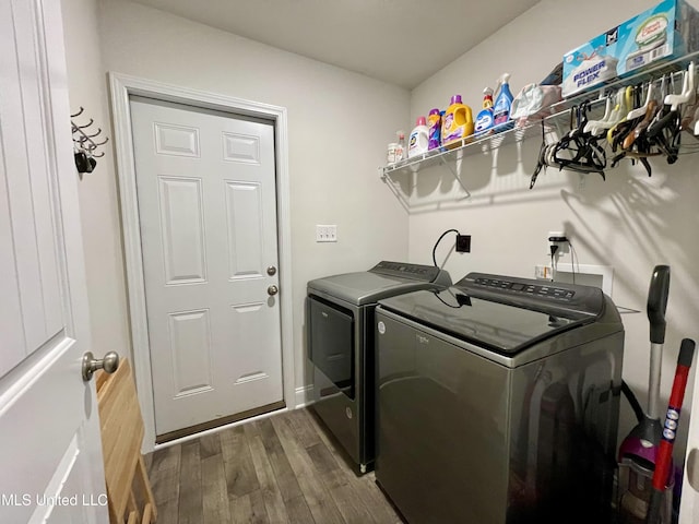 laundry room featuring dark wood-type flooring and washer and dryer