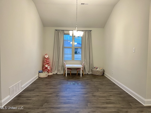 unfurnished dining area featuring dark hardwood / wood-style flooring, vaulted ceiling, and a notable chandelier