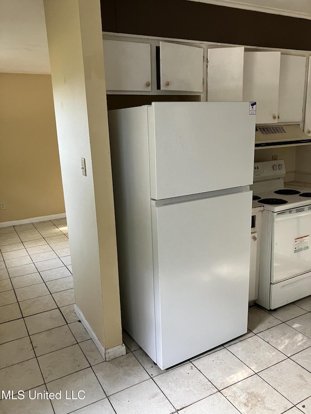 kitchen with white appliances, extractor fan, light tile patterned floors, and white cabinets
