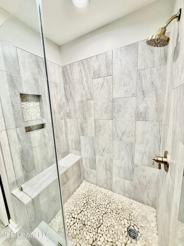 full bath with a tile shower