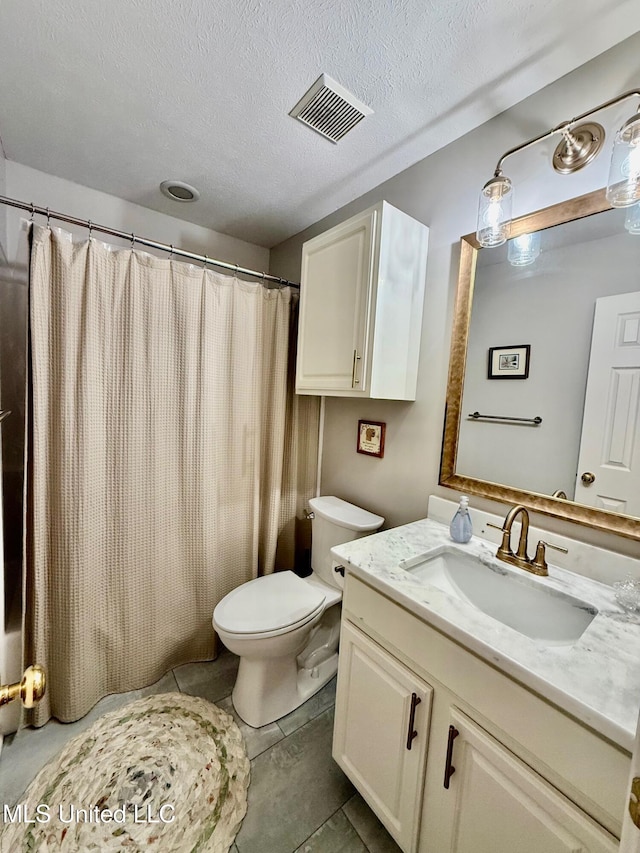 full bathroom featuring visible vents, a textured ceiling, toilet, and vanity