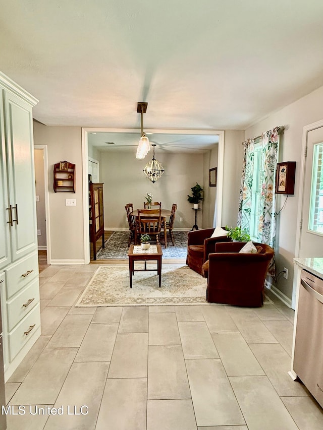 living room featuring light tile patterned floors and an inviting chandelier