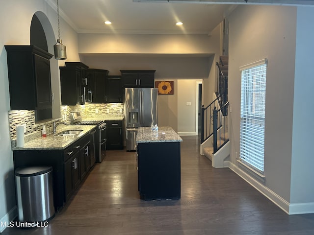 kitchen featuring decorative backsplash, appliances with stainless steel finishes, dark hardwood / wood-style flooring, and a kitchen island