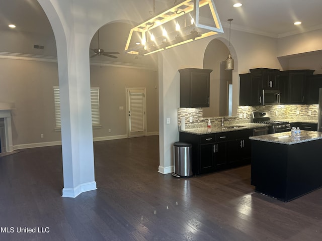 kitchen with sink, dark hardwood / wood-style flooring, pendant lighting, and appliances with stainless steel finishes