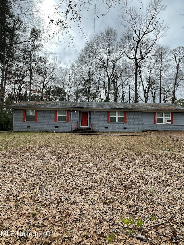 ranch-style house featuring brick siding and crawl space