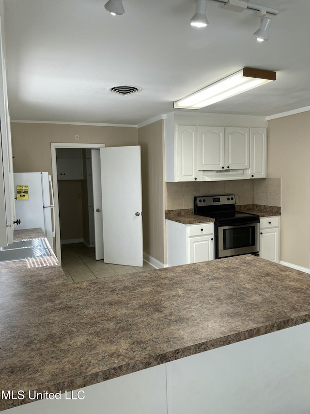 kitchen featuring dark countertops, white cabinets, stainless steel electric range, and visible vents