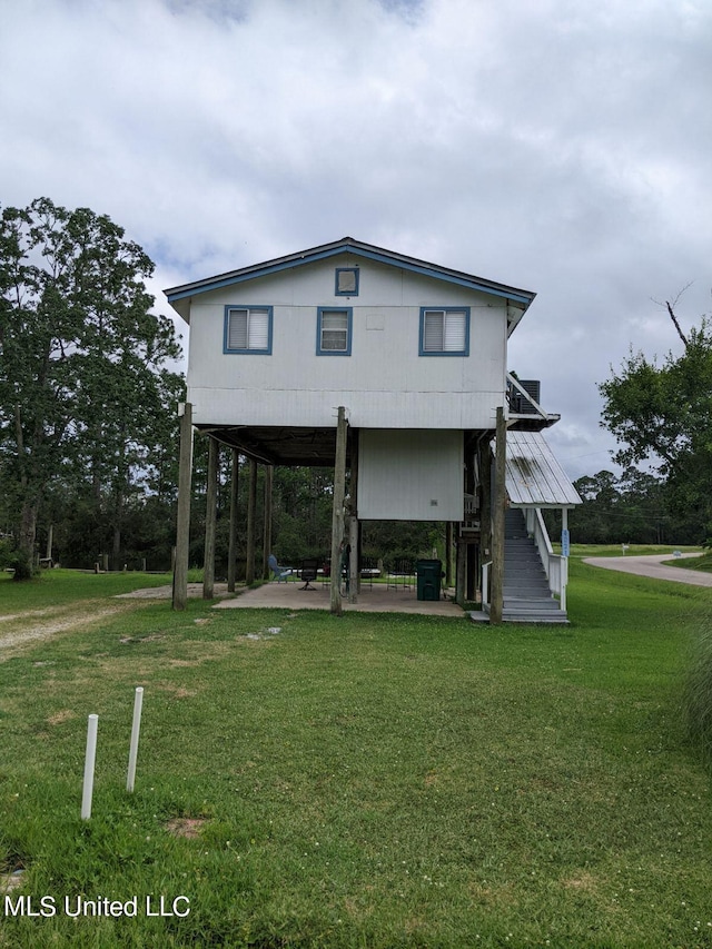 4021 Sailfish St, Bay Saint Louis, MS 39520 - back of house with a yard, stairs, and a patio