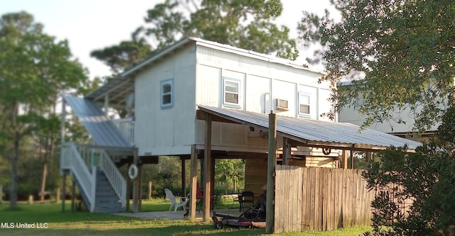 4021 Sailfish St, Bay Saint Louis, MS 39520 - back of house with metal roof, stairway, a lawn, a patio area, and cooling unit
