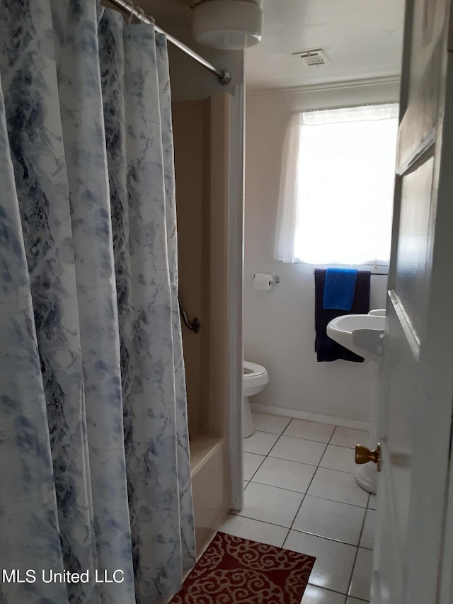 4021 Sailfish St, Bay Saint Louis, MS 39520 - full bath with tile patterned flooring, toilet, and shower / tub combo