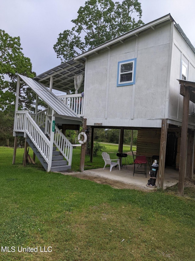 4021 Sailfish St, Bay Saint Louis, MS 39520 - rear view of house featuring a patio area, stairway, a lawn, and a deck