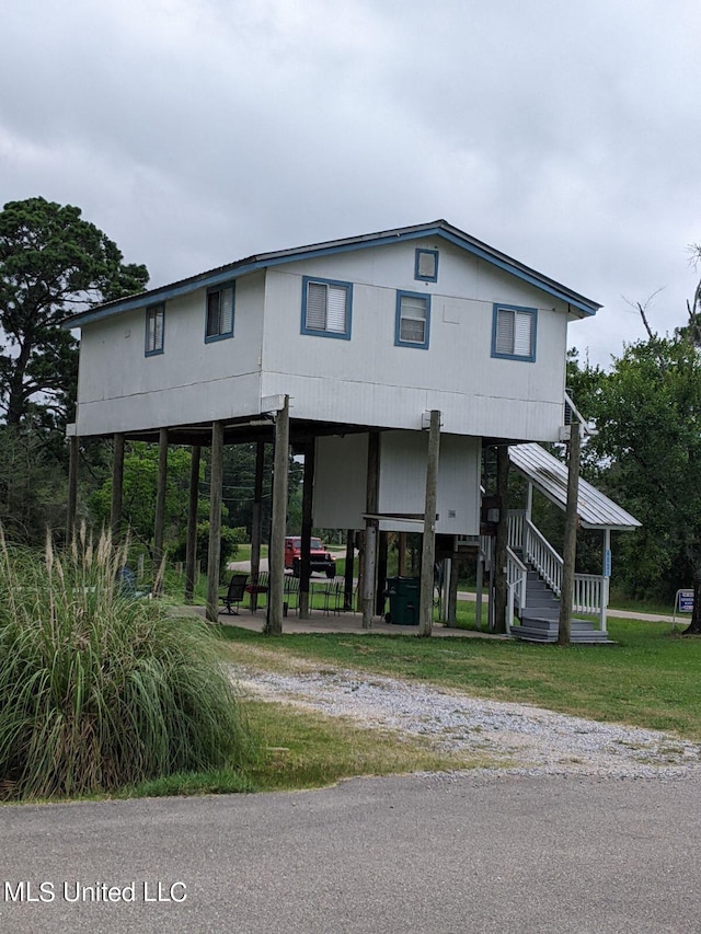 4021 Sailfish St, Bay Saint Louis, MS 39520 - raised beach house with a carport