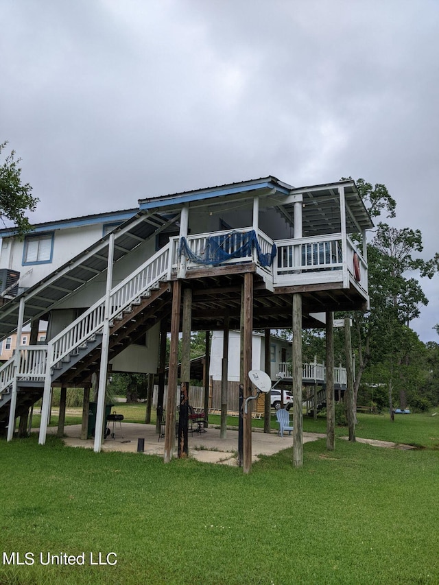 4021 Sailfish St, Bay Saint Louis, MS 39520 - rear view of house with a lawn, a deck, and stairway