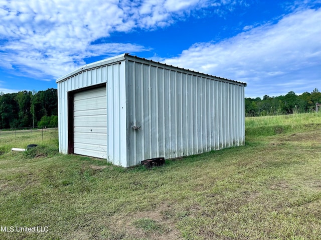 view of outbuilding featuring a yard and a garage