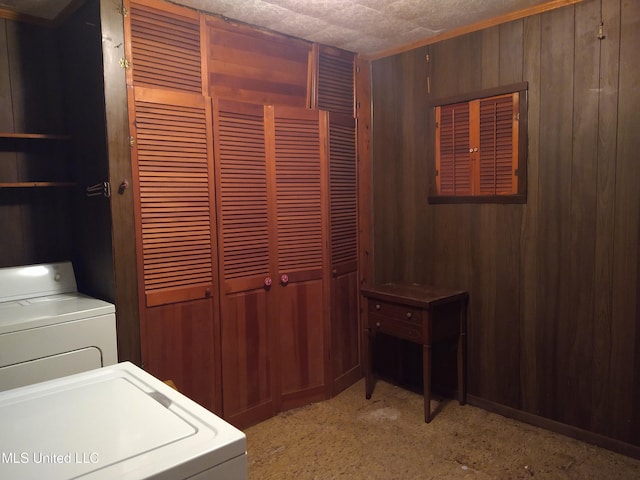 washroom with wooden walls and washer and clothes dryer