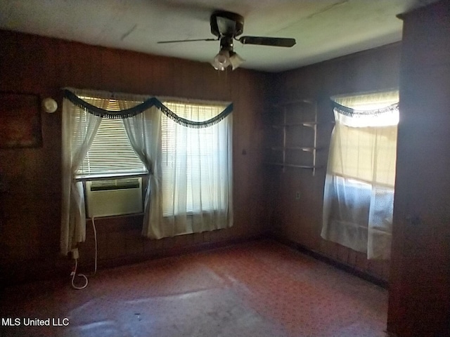 carpeted empty room featuring cooling unit, a healthy amount of sunlight, and ceiling fan