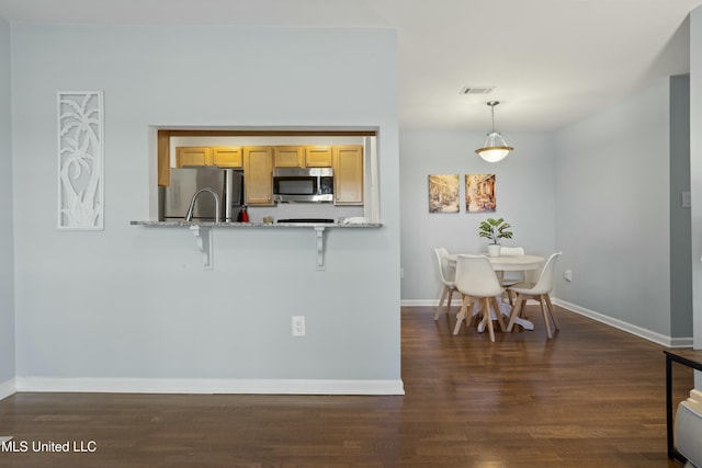 kitchen featuring baseboards, visible vents, stainless steel appliances, and dark wood-style flooring