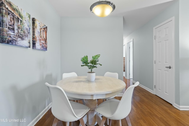 dining room featuring baseboards and wood finished floors