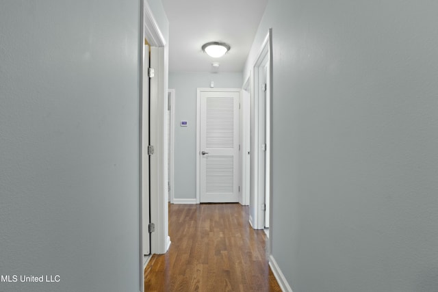 hall featuring dark wood finished floors and baseboards