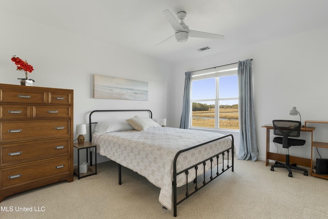 bedroom featuring ceiling fan, visible vents, baseboards, and light colored carpet