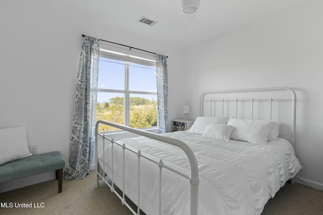 bedroom with carpet, visible vents, and baseboards