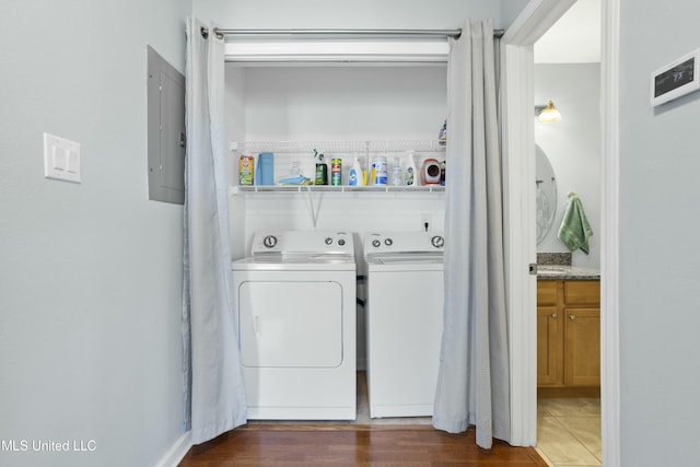 washroom featuring laundry area, electric panel, dark wood finished floors, and separate washer and dryer