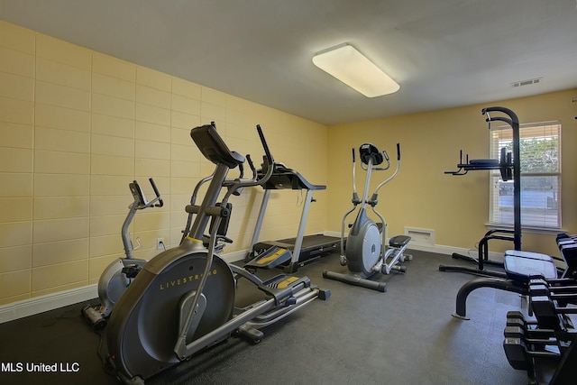 exercise area with baseboards and visible vents