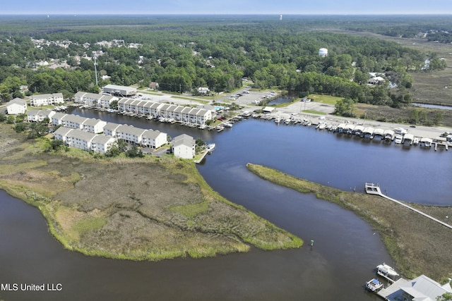 drone / aerial view featuring a water view and a wooded view