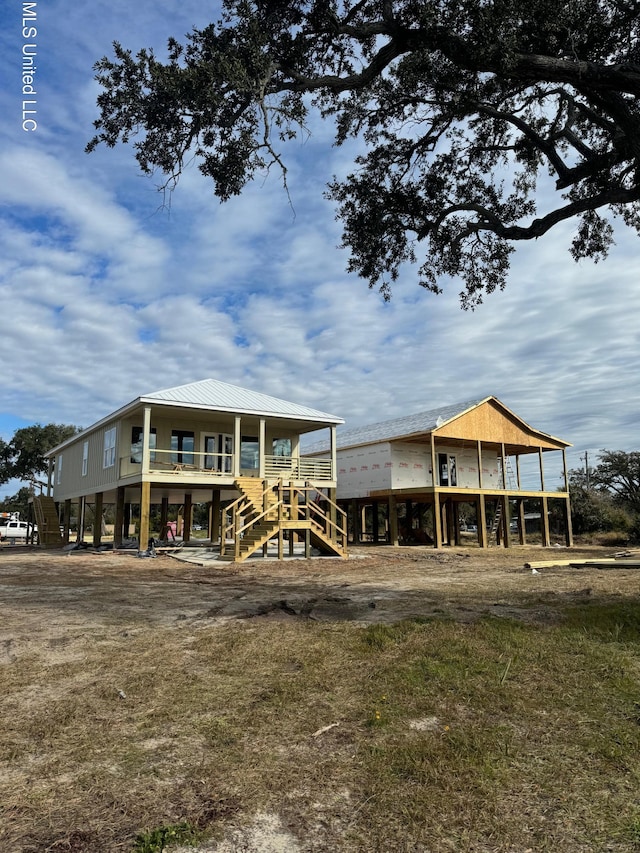 534 Beach Dr, Gulfport, MS 39507 - rear view of property featuring stairway and metal roof