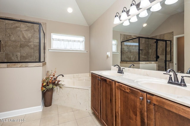 3289 Marion Ln, Southaven, MS 38672 - full bath with lofted ceiling, a garden tub, a stall shower, double vanity, and tile patterned floors