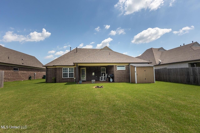 3289 Marion Ln, Southaven, MS 38672 - back of house with a storage shed, a fenced backyard, brick siding, and roof with shingles