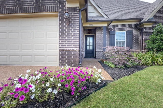 3289 Marion Ln, Southaven, MS 38672 - doorway to property featuring brick siding, a shingled roof, and a garage