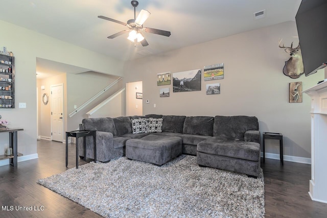 3289 Marion Ln, Southaven, MS 38672 - living area with dark wood finished floors, a ceiling fan, and stairs