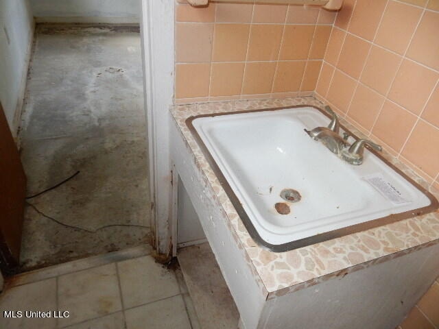 bathroom with tile walls and tile patterned floors