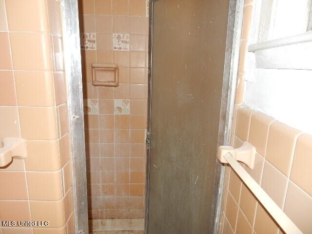 bathroom with a shower with door