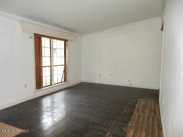 empty room with dark hardwood / wood-style floors