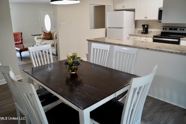 dining area with dark hardwood / wood-style floors