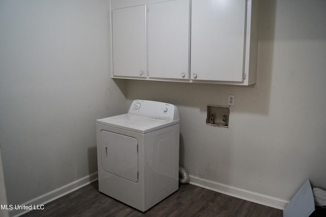 clothes washing area with washer / clothes dryer, cabinets, and dark hardwood / wood-style floors