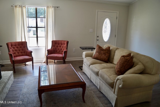 living room featuring crown molding, a brick fireplace, and dark hardwood / wood-style floors