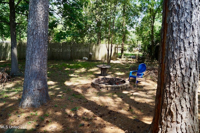 view of yard with a fire pit