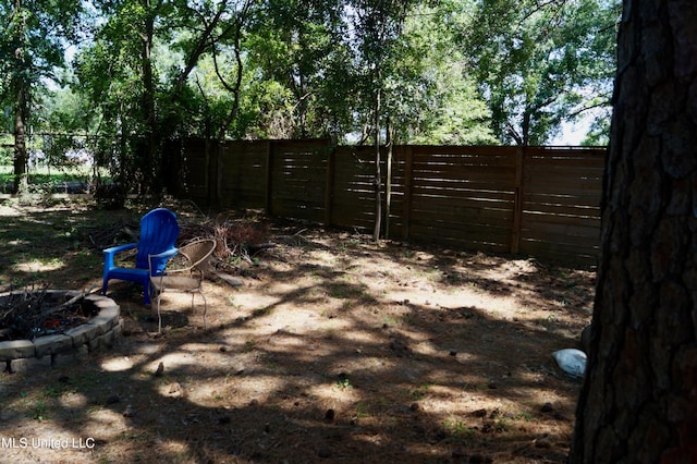 view of yard with a fire pit