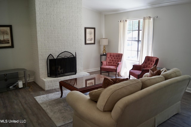 living room featuring ornamental molding, dark hardwood / wood-style floors, and a fireplace