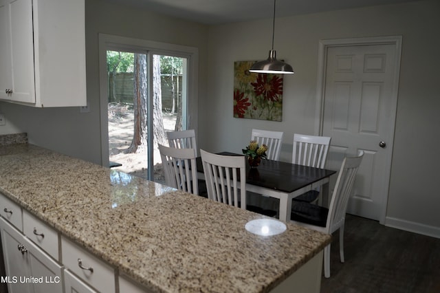 dining area featuring dark wood-type flooring