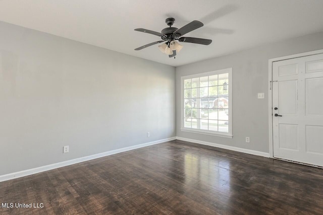interior space with baseboards, ceiling fan, and dark wood-style floors