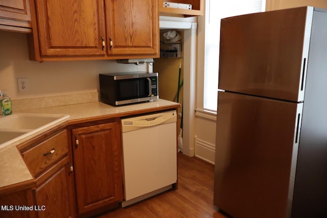 1009 Resca De La Palma St, Pascagoula, MS 39567 - kitchen featuring appliances with stainless steel finishes, wood finished floors, brown cabinets, and light countertops
