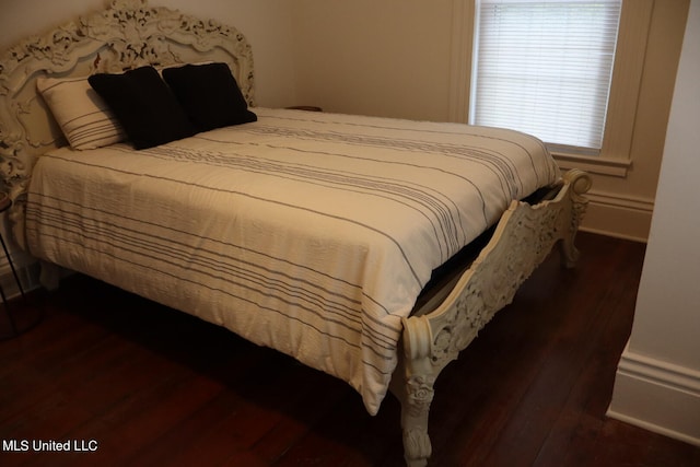 bedroom featuring dark hardwood / wood-style flooring